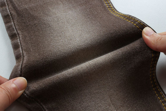 अच्छा दाम सुपर ब्राउन स्ट्रेच डेनिम कपड़े महिलाओं के लिए पुरुष जींस कम स्ट्रेच प्रतिस्पर्धी मूल्य चीन से Foshan शहर ऑनलाइन